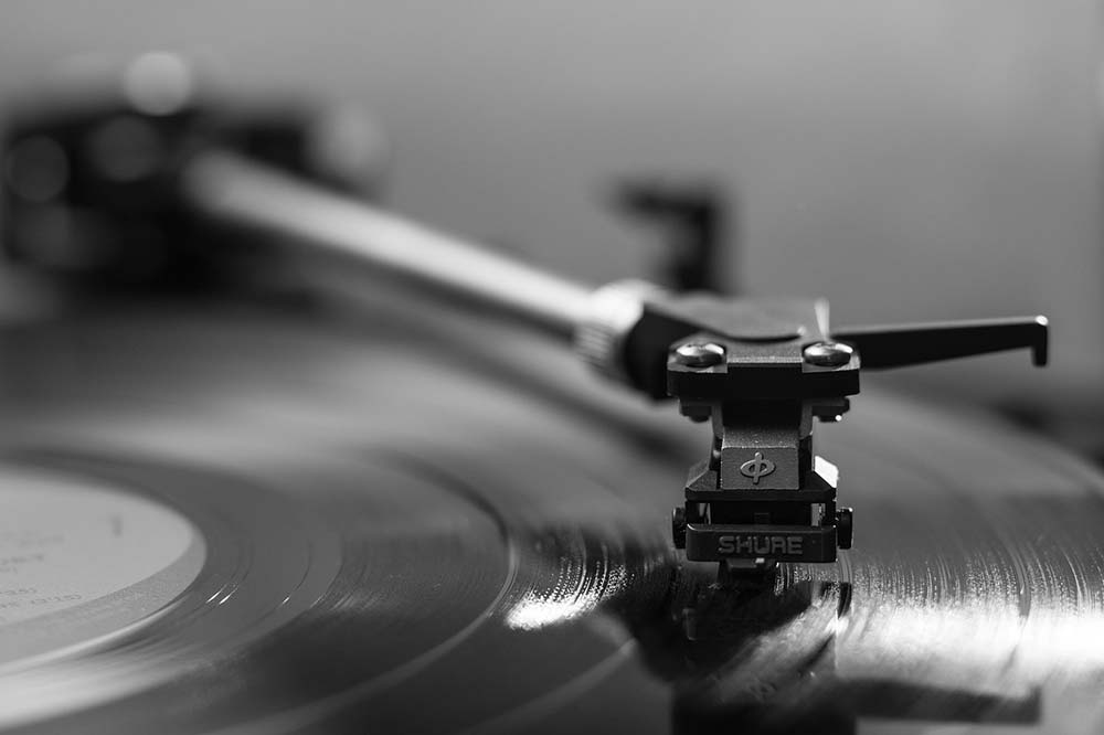 black and white picture of a vinyl on a record player